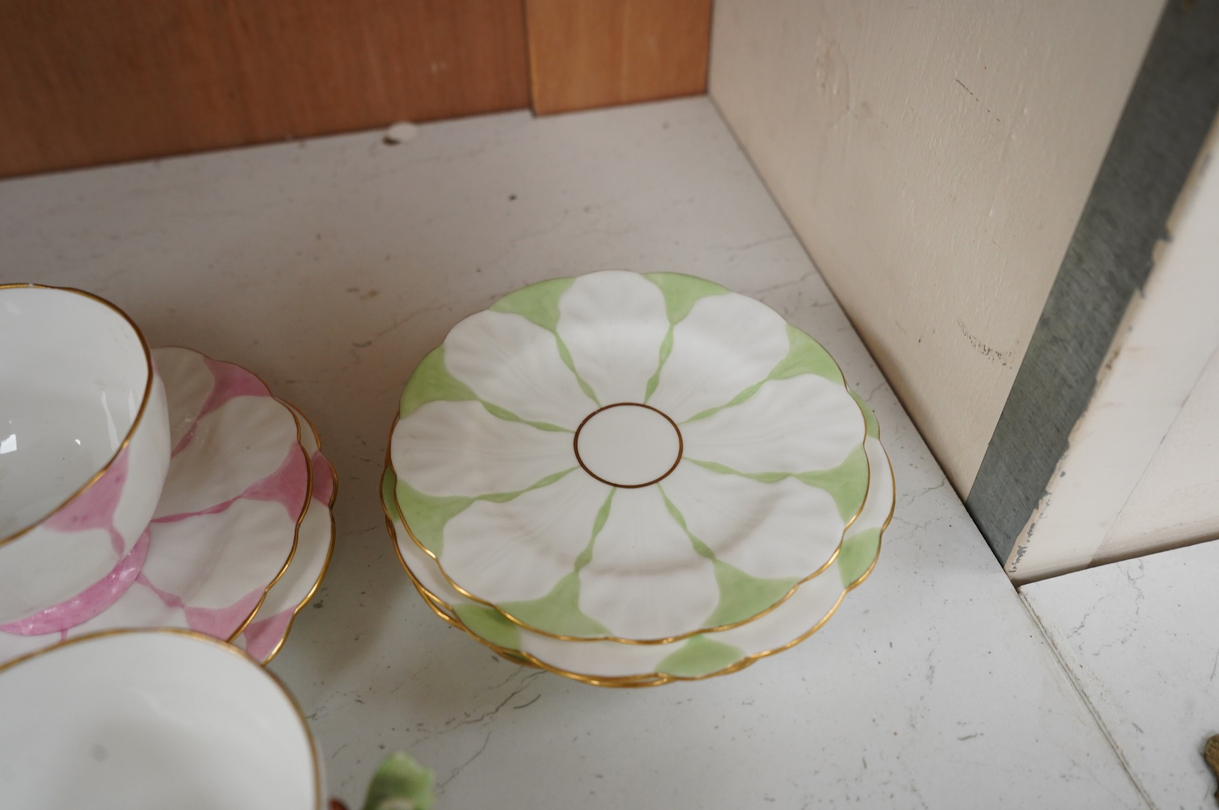 Two Aynsley trios with butterfly handles and one extra saucer, numbered 785788